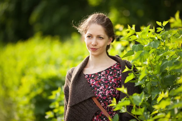 Beautiful happy woman in a dress and cardigan — Stock Photo, Image