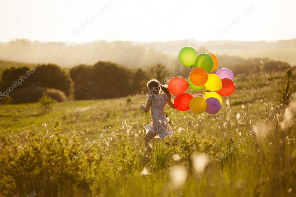 Happy little girl running across the field