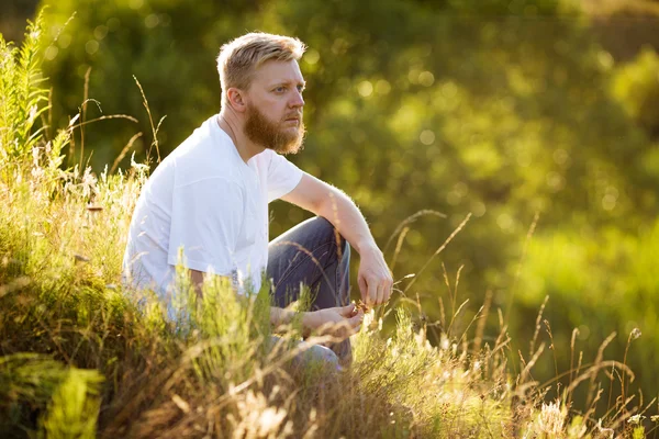 Guy sitting on the grass — Stock Photo, Image