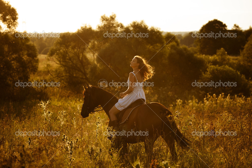 Girl on a horse of high grass