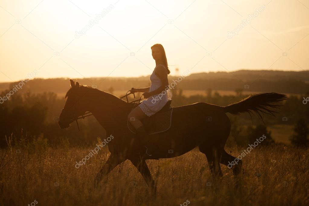 Girl on a horse at sunset