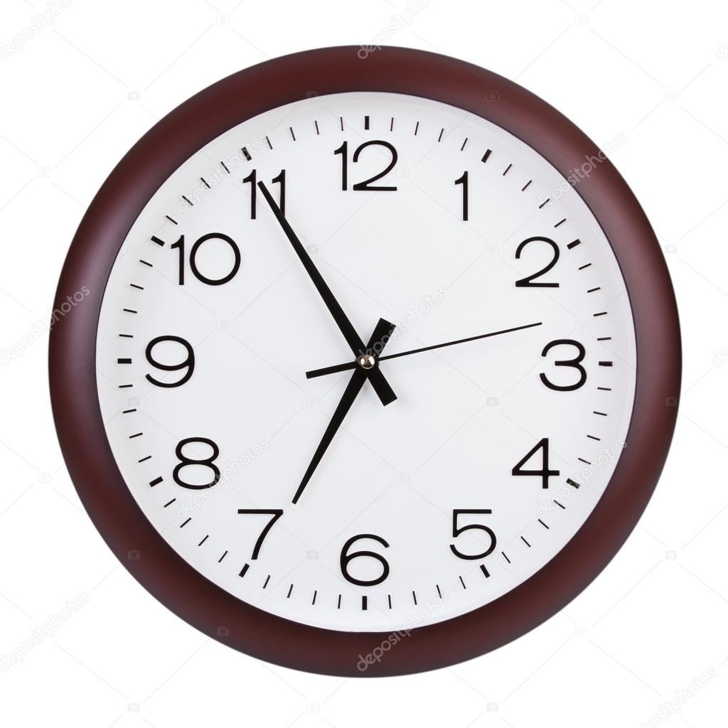 Round clock shows five minutes to seven