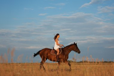 Young woman riding a horse clipart