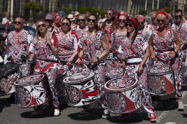 Bath, England, United Kingdom - 9 July 2022: Drumming band performing at the annual carnival as it progresses through the streets of the historic city of Bath in Somerset.