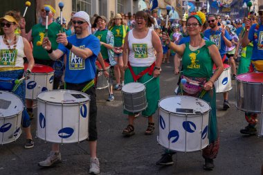 Bath, England, United Kingdom - 9 July 2022: Drumming band performing at the annual carnival as it progresses through the streets of the historic city of Bath in Somerset.