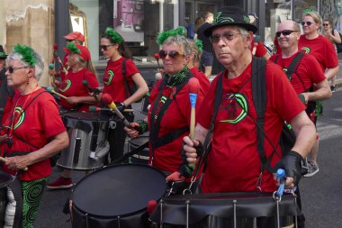 Bath, England, United Kingdom - 9 July 2022: Drumming band performing at the annual carnival as it progresses through the streets of the historic city of Bath in Somerset.