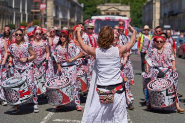 Bath, England, United Kingdom - 9 July 2022: Drumming band performing at the annual carnival in the historic city of Bath in Somerset.