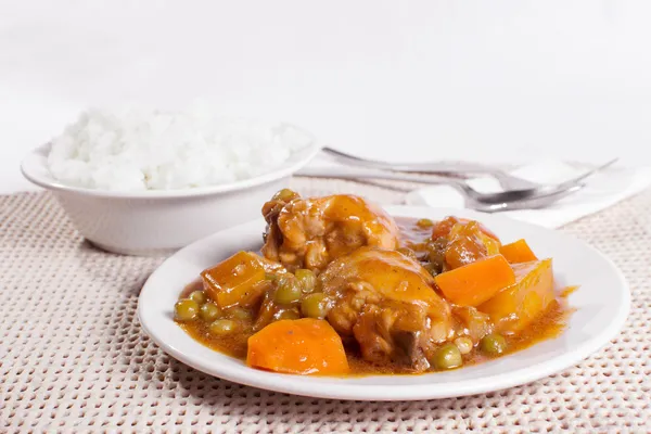 Chicken afritada with bowl of rice — Stock Photo, Image