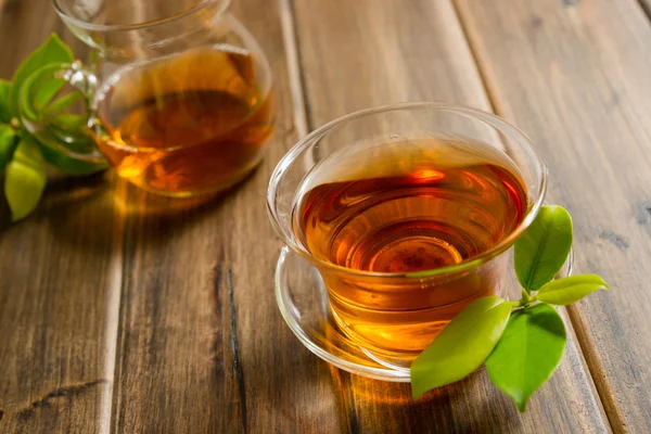 Black tea on wooden table — Stock Photo, Image