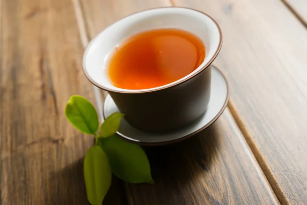 Teacup on a wooden table — Stock Photo, Image