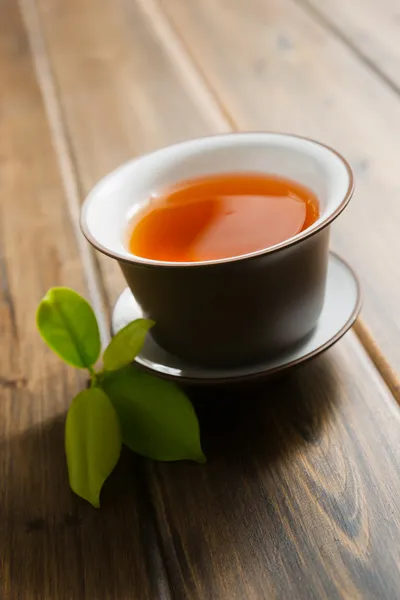 Black tea on wooden table — Stock Photo, Image