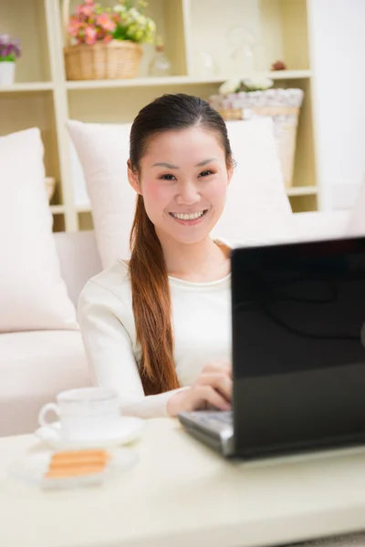 Young asian woman using a laptop Stock Image