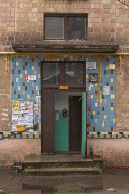 Entrance to the staircase in the old Soviet multisrorey dirt  house building of the 1960s. Kyiv, Ukraine - December 2021.