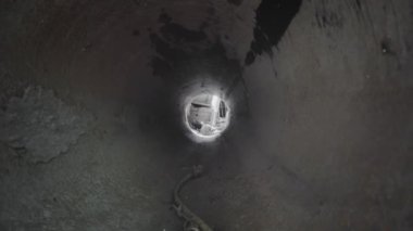 Exit from the dry drainage sewage tunnel pipe. Concrete Drainage Pipe, collector of city sewage system. Dolly.