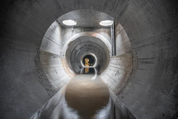 New concrete drainage rainwater collector, in a concrete pipe, inside view.