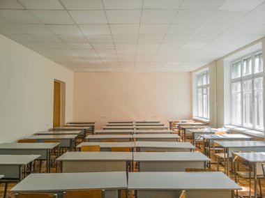 Öğleden sonraları bej duvarlı boş eski sınıf. Kyiv, Ukrayna - Haziran 2022.