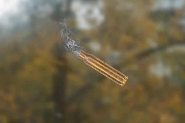Used firearms cartridge 5,56 x 45  with smoke in flight after shot.