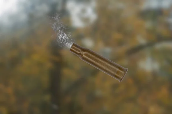 Used firearms cartridge 7,62 mm with smoke in flight after shot.