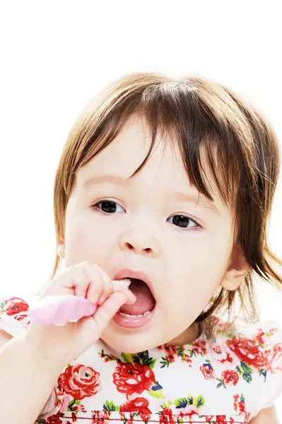 Infant cleans teeth Stock Photo