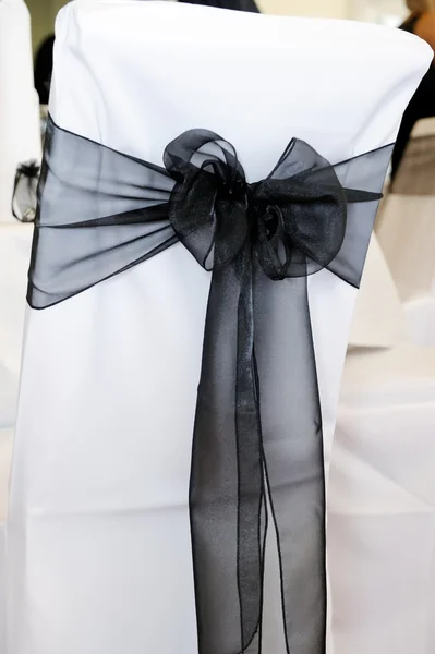 Black chair cover at wedding — Stock Photo, Image