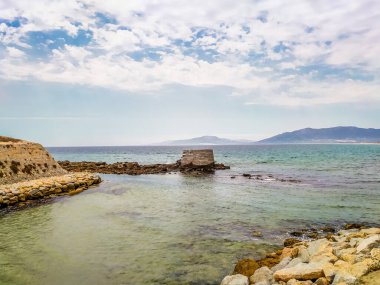 Taş sahili. Tuğlayı suya bırak. Ortaçağ işkencesi. Suyun üzerinde bina.