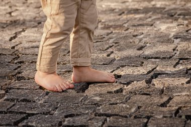 Bare children's feet on the cobblestones. The child is barefoot. Children's bare feet. Walk without shoes. Go forward. Freedom to be yourself.