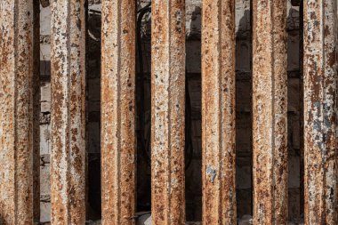 A rusty cast-iron battery in a burnt-out house. A rusty cast-iron battery in a burnt-out house. Cast iron battery. Heating device. The place of the fire. Burnt apartment. Conflagration place. Seat of fire. 