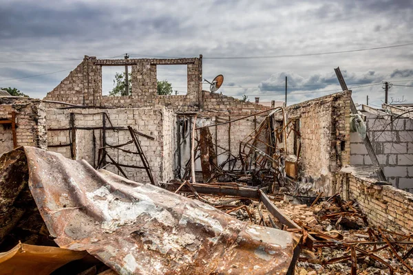 Ruined house. Ruins of a residential building. Brick walls. War in Ukraine. A house destroyed by a rocket and fire. A pile of bricks. A burnt life. Russian peace. Consequences of Russian aggression and occupation.