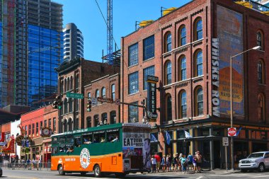 Nashville, TN, USA  September 21, 2019 Old Town Trolley Tour bus drives by Country music star Dierks Bentleys Whiskey Row bar on the popular Broadway Street.