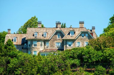 Ottawa, Canada - June 19, 2014: The official residence of the Prime Minister of Canada at 24 Sussex from the Ottawa River. The house was built in 1868 and is in need of extensive upgrades and repairs, no PM has lived there since 2015.
