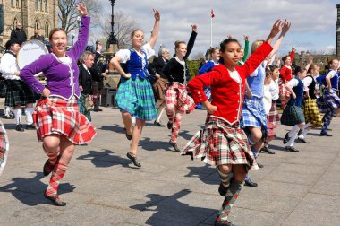 Ottawa, Canada - April 11, 2010:  Scottish Highland Dancers perform at the National Tartan Day celebration on Parliament Hill Ottawa, Ontario. clipart