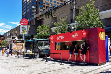 Montreal, Canada - July 3, 2022: Kiosks selling food, beer and wine on Saint-Catherine Street during the annual Montreal Jazz Festival a popular tourist attraction.