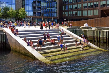 Halifax, Nova Scotia July 31, 2022: People on the stairs that lead into Halifax Harbour. The stairs known as known as Queen`s Landing were opened in 2021 as part of the Queen`s Marque on the Halifax Waterfront and have led to safety concerns.