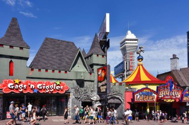Niagara Falls, Canada August 13, 2022 Some of the several tourist attractions on the busy street Clifton Hill. Casino Niagara tower can be seen in the background.