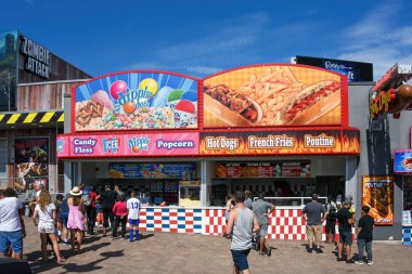 Niagara Falls, Canada - August 13, 2022: Food stands serving carnival food to the many tourists drawn to the area near Clifton Hill that has several tourist attractions.