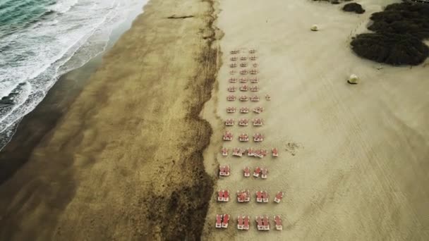 ビーチで折り畳まれたビーチの傘と空のサンベッドの行は グラン カナリア島 最上階だ 旅行とレジャーのコンセプト — ストック動画