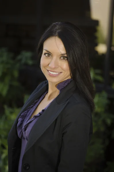 Attractive business woman turning around with big smile