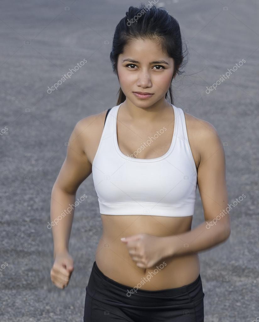 Young woman in sports bra and shorts running outside Stock Photo by ©AVFC  25706213