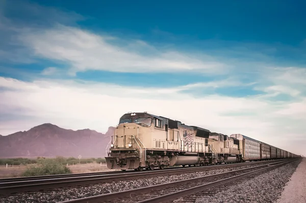 Freight train traveling through desert — Stock Photo, Image