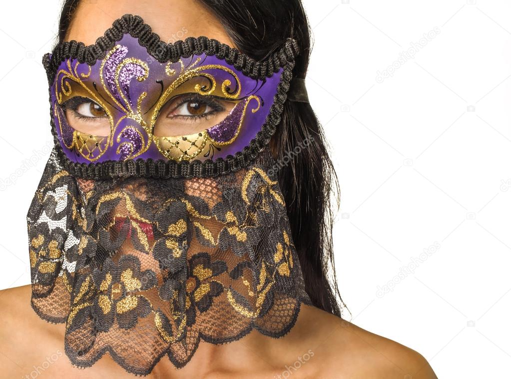 Beautiful mysterious woman's face behind ornate purple and gold mask