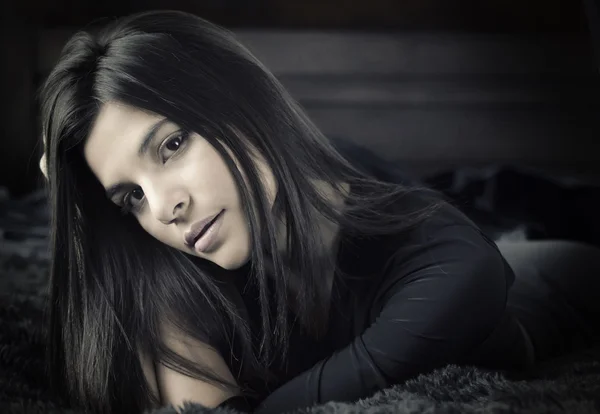 Face of beautiful young woman lying on bed — Stock Photo, Image