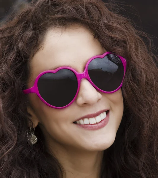 Happy smiling woman's face wearing heart shape glasses — Stock Photo, Image