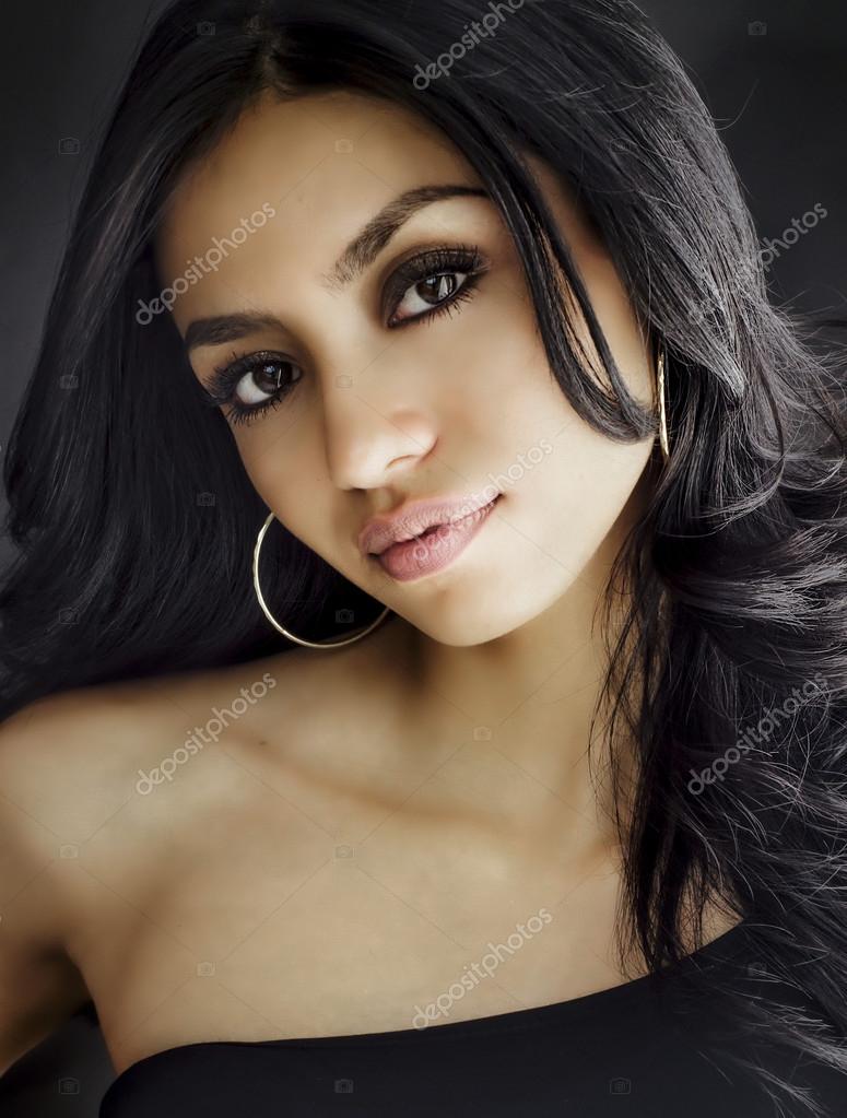 Beautiful exotic looking woman smiling — Stock Photo © paulmhill 43063681