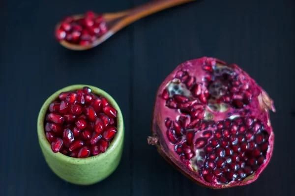 Pomegranate seeds portion in green pottery — Stock Photo, Image