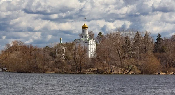 Christian church on a river coast — Stock Photo, Image