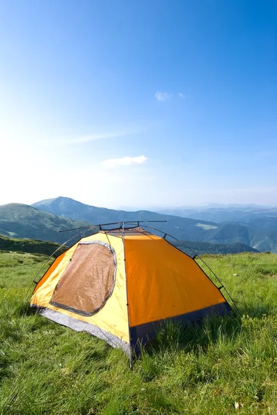 Orange touristic tent in a mountain prairie — Stock Photo, Image