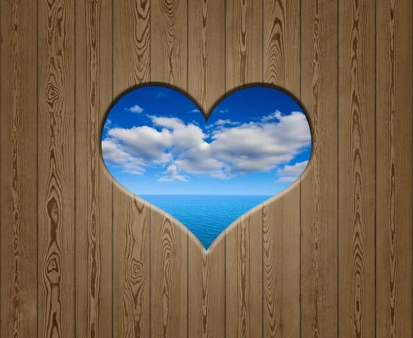 Wooden wall with heart like hole — Stock Photo, Image