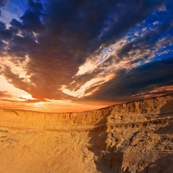 Sunset over a desert dunes