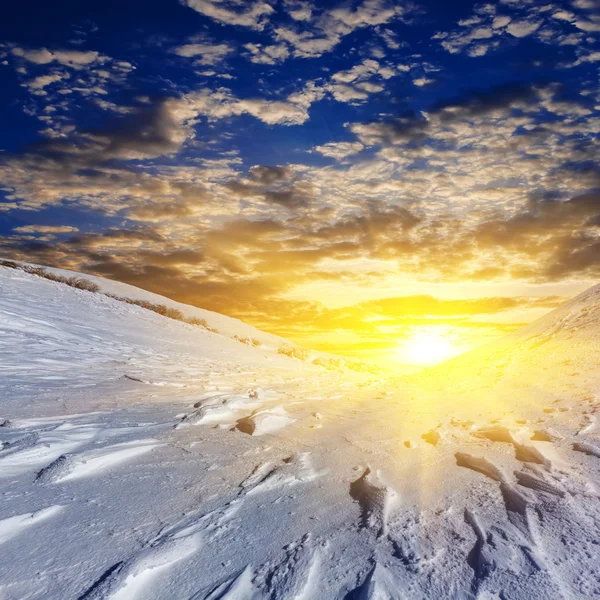 Evening snowbound plain by a sunset — Stock Photo, Image