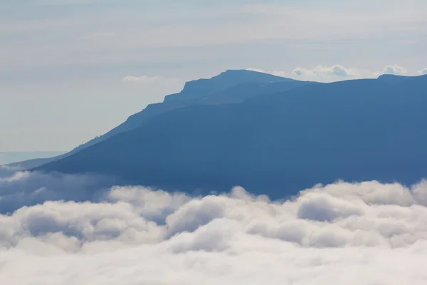 Monte declive entre nuvens densas — Fotografia de Stock
